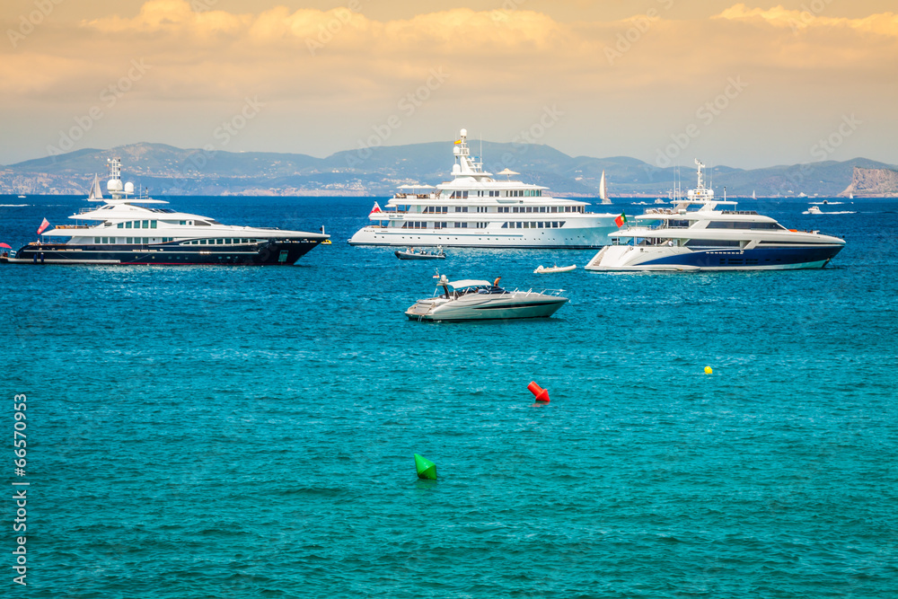 Luxury yachts in turquoise beach of Formentera Illetes