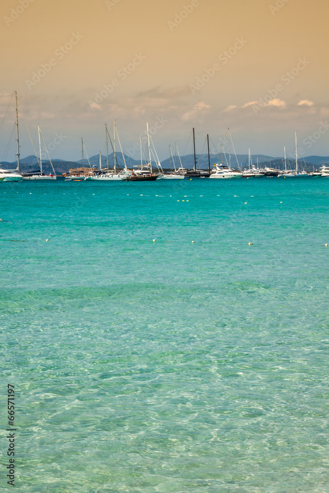 Luxury yachts in turquoise beach of Formentera Illetes
