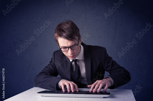 Hacker working with keyboard on blue background