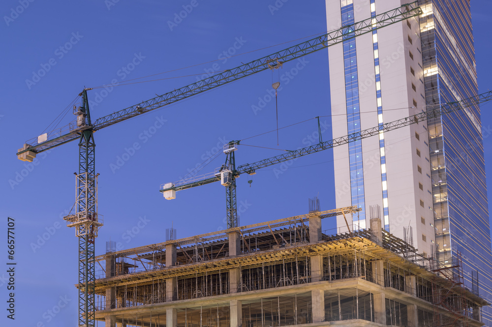 Building under construction with cranes