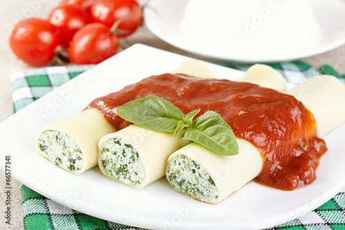 Cannelloni with spinach and ricotta under tomato sauce