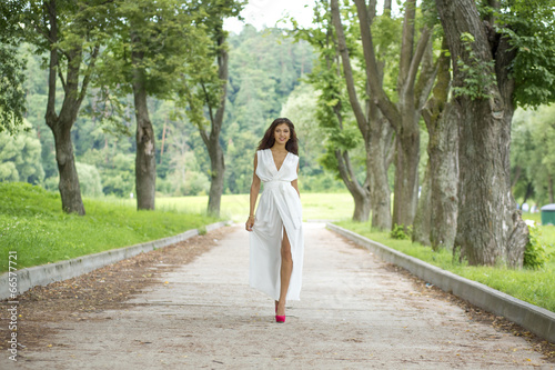 Happy young woman in sexy white dress