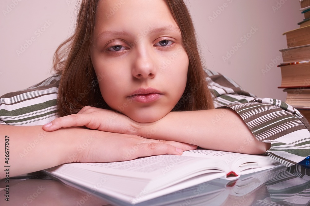 Teen girl sitting with books