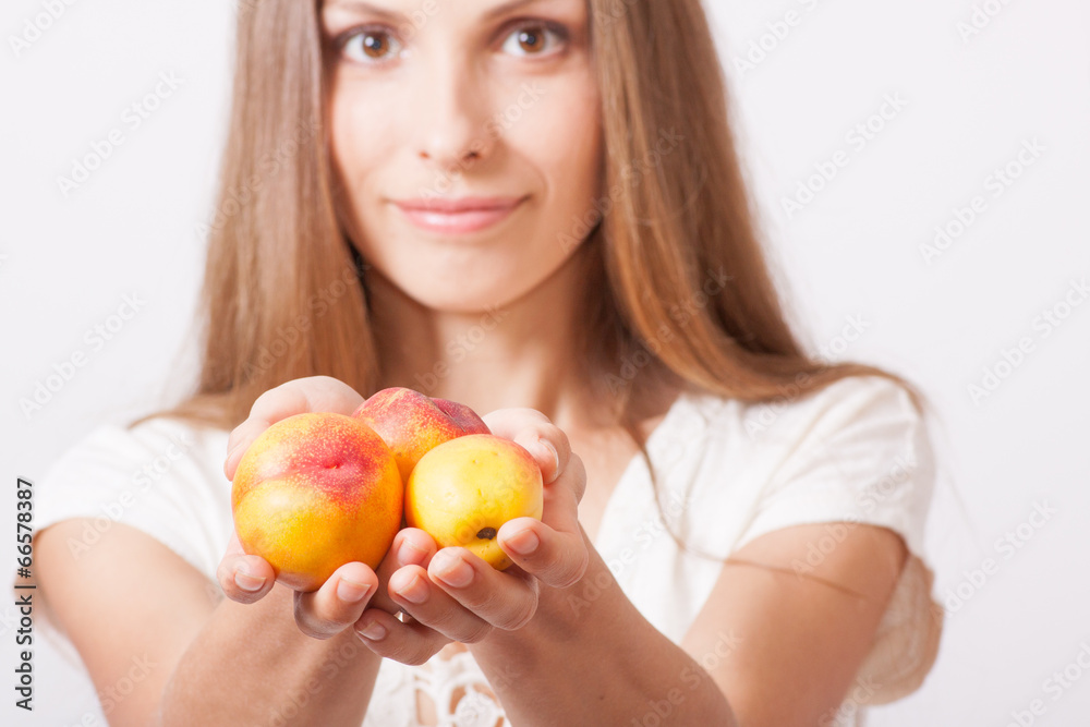 peaches in hand, isolated on white peaches in hand, isolated on white