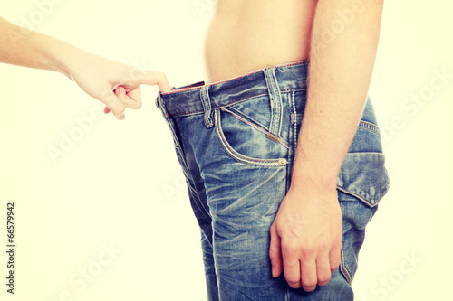 Girl looking in mens pants.