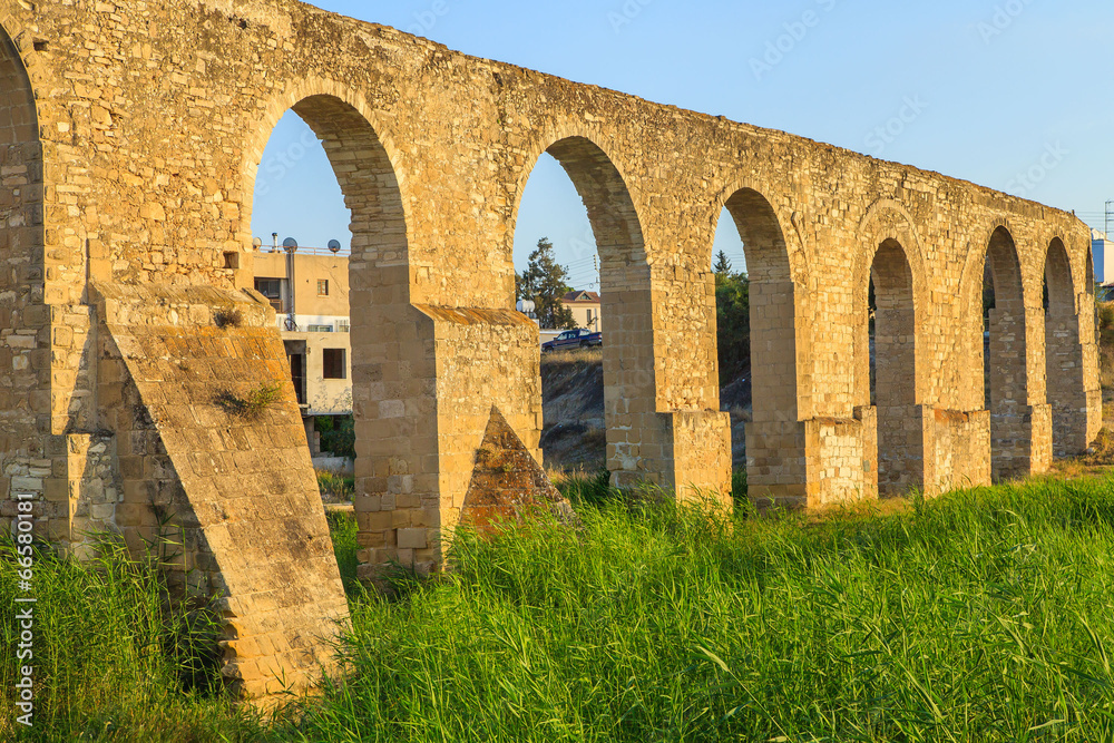 Old Greek aqueduct in warm sunset light in Larnaca, Cyprus