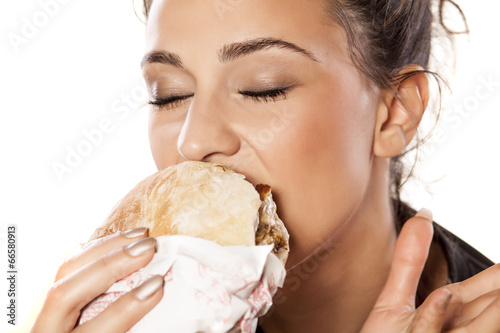 beautiful girl voraciously eating her sandwich