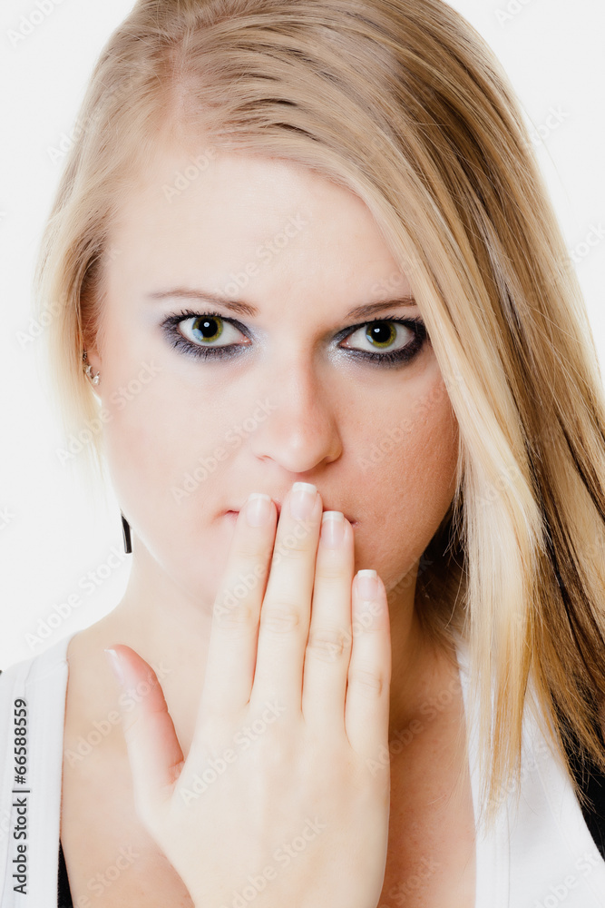 Surprised afraid girl covering mouth with hand