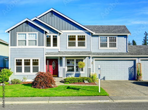 Big two story house. View of entance porch and garage photo