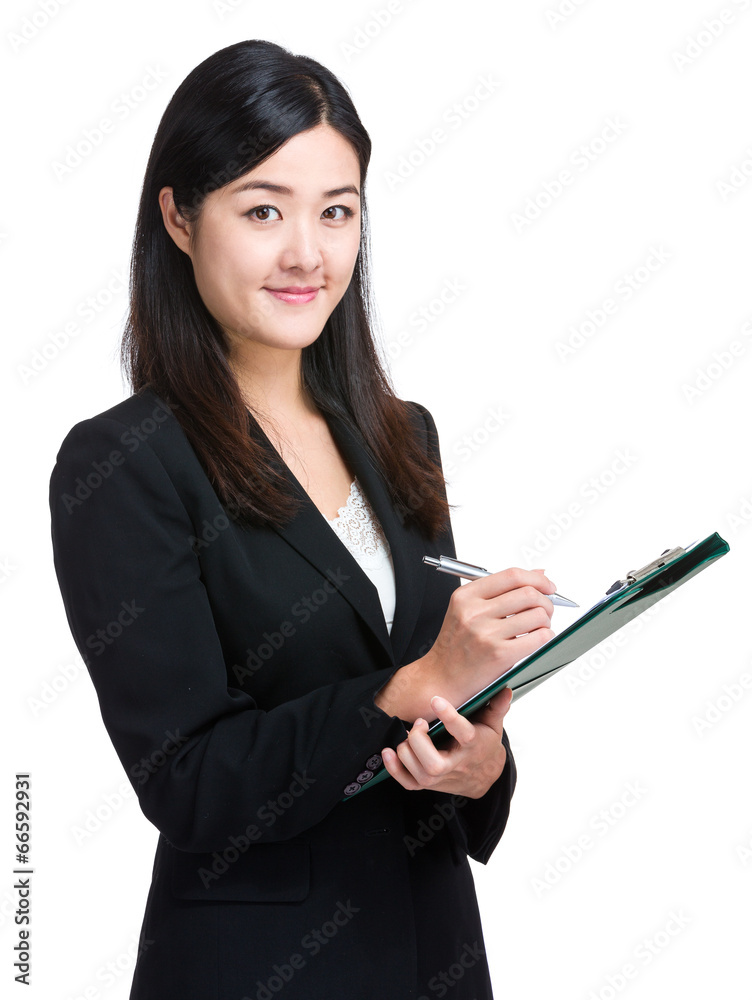 Asian businesswoman take note on clipboard Asian businesswoman take note on clipboard