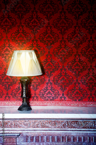 Vintage lamp on a retro fireplace toned image