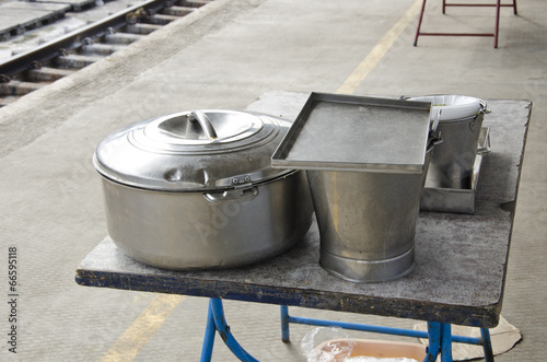 metal pot and bucket for food in train station, India