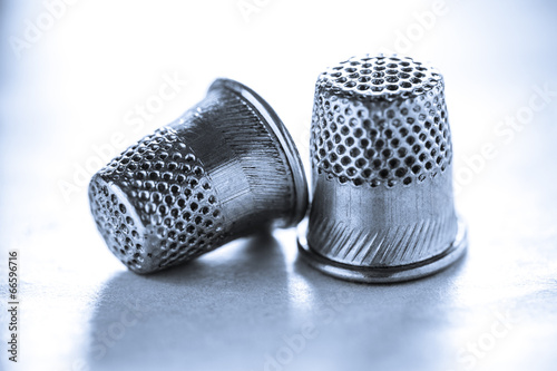 Two metal sewing thimbles