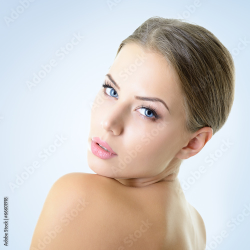 Portrait of attractive young woman over blue background