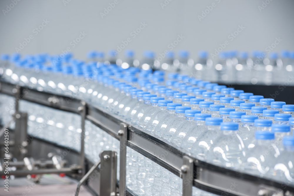 Plastic bottles on conveyor belt Plastic bottles on conveyor belt