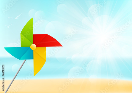 Color paper pinwheel on sea background photo