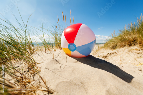 Beach ball in sand dune photo
