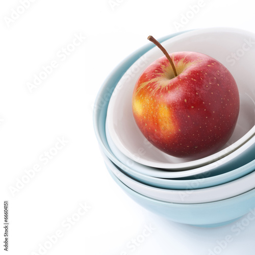 different clean bowl and red apple, close-up, isolated