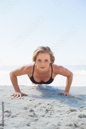 Fit blonde in plank position on the beach © WavebreakMediaMicro