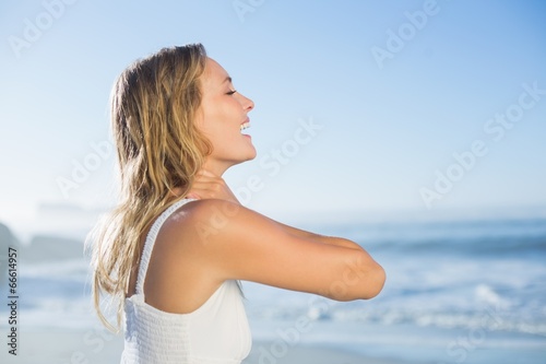 Pretty blonde standing at the beach in white sundress © WavebreakMediaMicro