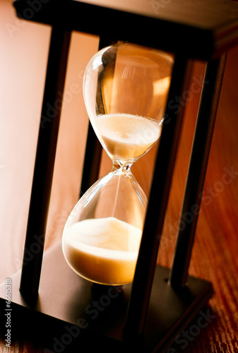 Wooden hourglass with running sand