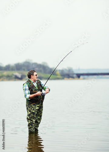 Fisherman angling on the river