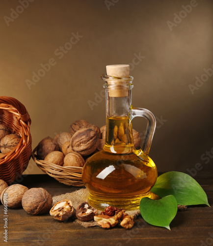 Walnut oil and nuts on wooden table photo