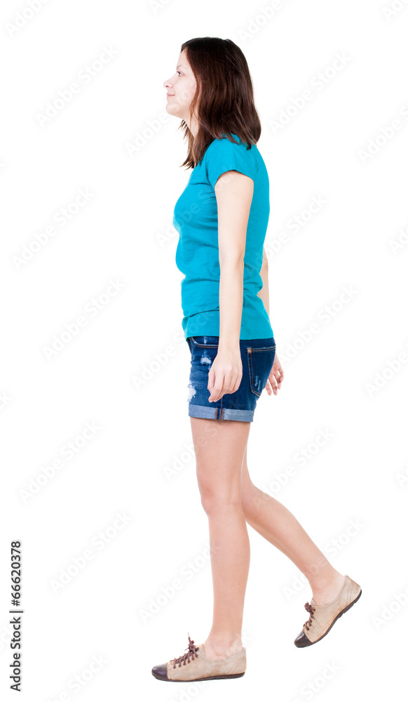 back view of walking woman in shorts. back view of walking woman in shorts.