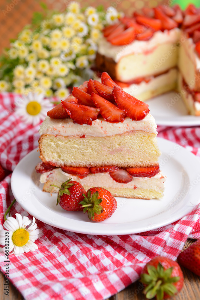 Delicious biscuit cake with strawberries on table close-up Delicious biscuit cake with strawberries on table close-up