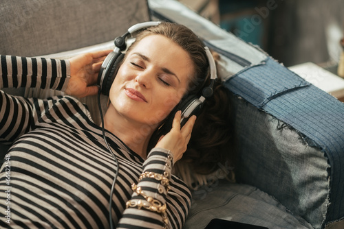 Portrait of young woman listening music in headphones  photo