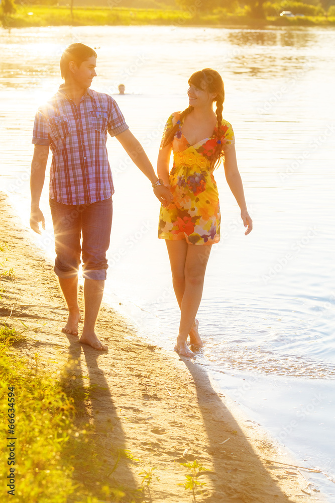 Happy couple in love walking on the beach. Summer vacations conc