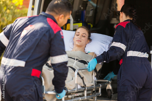 paramedics taking patient into an ambulance