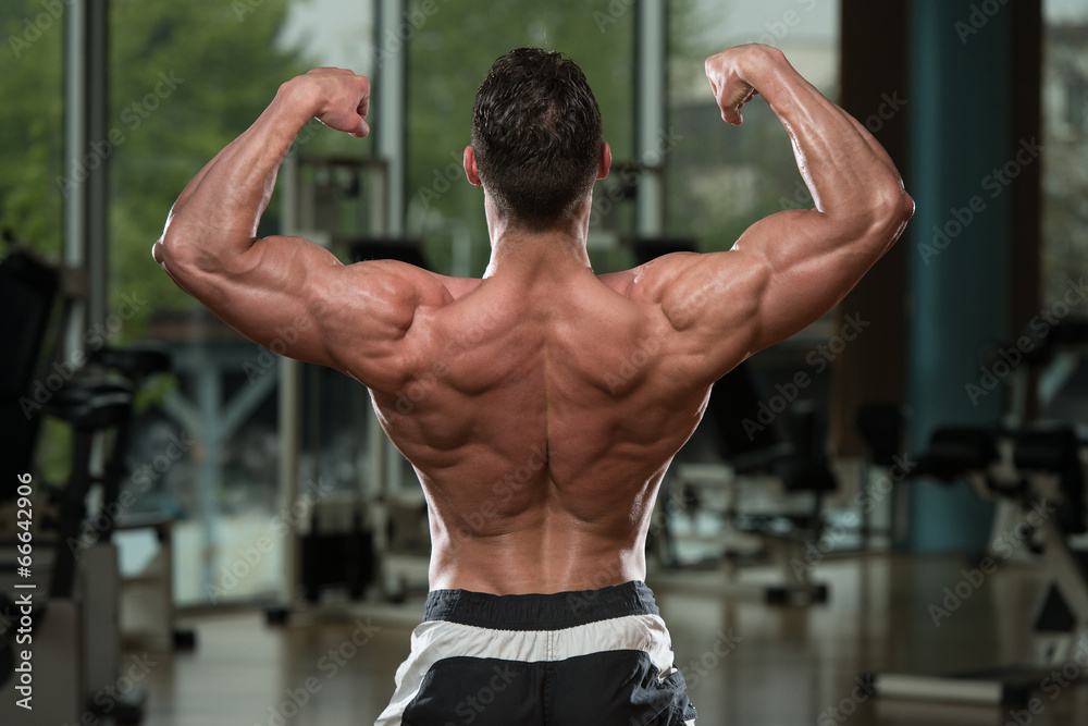 Bodybuilder Performing Rear Double Biceps Pose Stock Photo | Adobe Stock