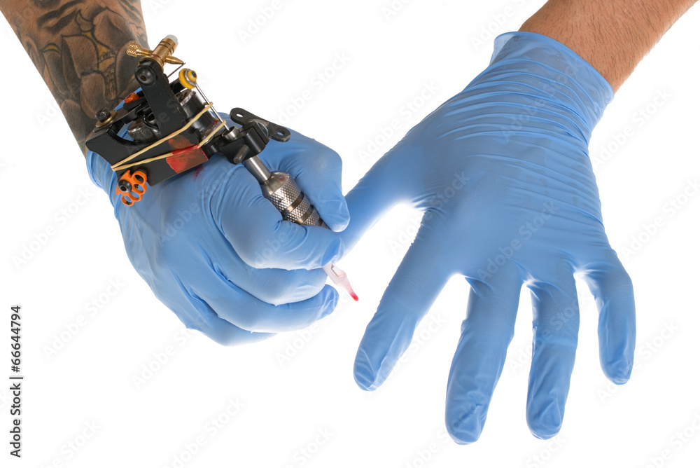 Tattoo artist at work isolated on white. Closeup Tattoo artist at work isolated on white. Closeup