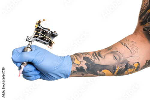 Tattoo artist at work isolated on white. Closeup