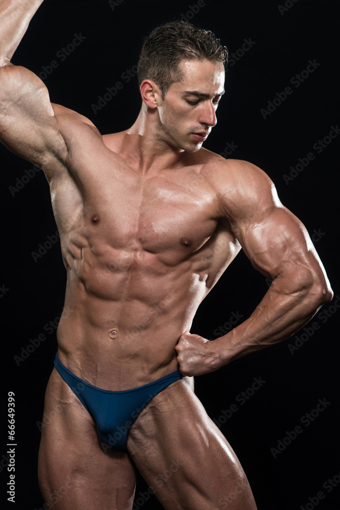 Serious Men Standing And Flexing Muscles Serious Men Standing And Flexing Muscles