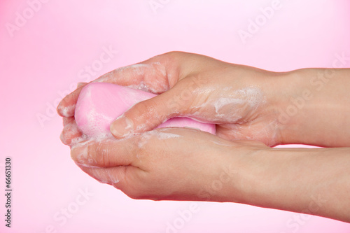 Piece of toilet soap in the female hands