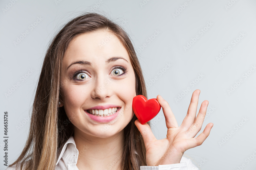 Portrait of a cheerful female holding a heart Portrait of a cheerful female holding a heart
