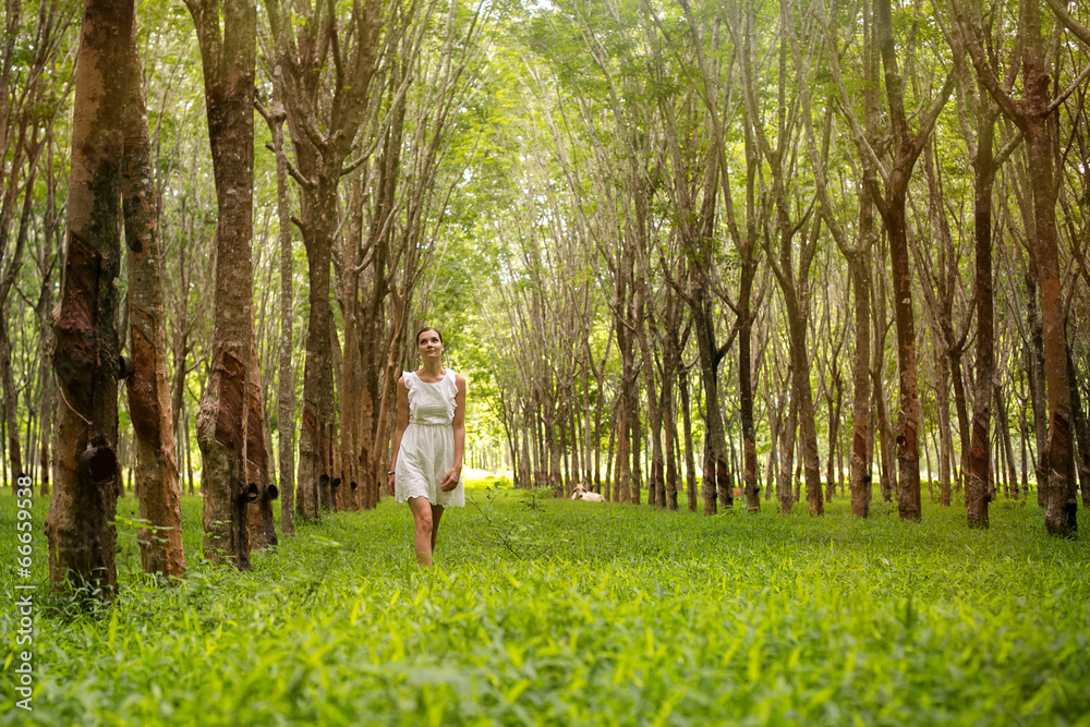 Beautiful romantic woman walking in the forest