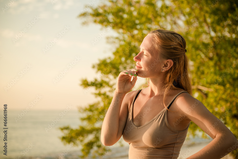 Fototapeta premium Woman watching sunset