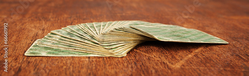 Photography deck of playing cards expanded on fan shape on wooden table