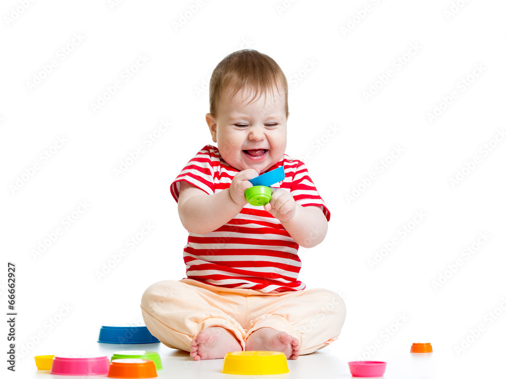 Funny little child playing with toys isolated over white Funny little child playing with toys isolated over white