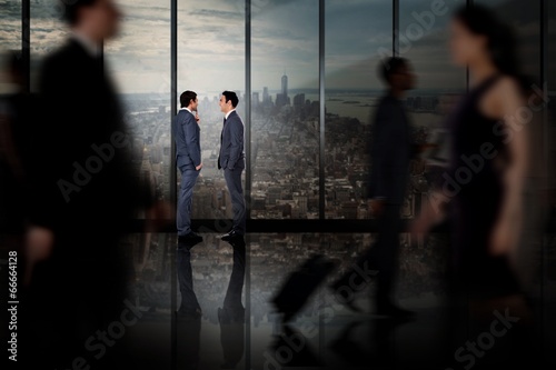 Composite image of businessmen talking
