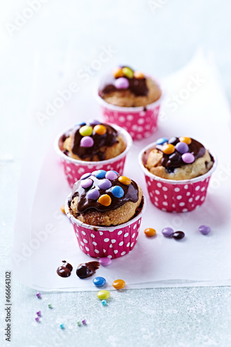 Colorful Muffins with Chocolate Glaze and Chocolate Beans