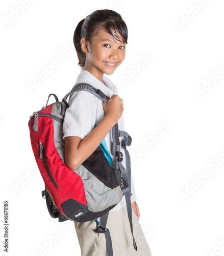 Young Asian school girl with backpack in school uniform