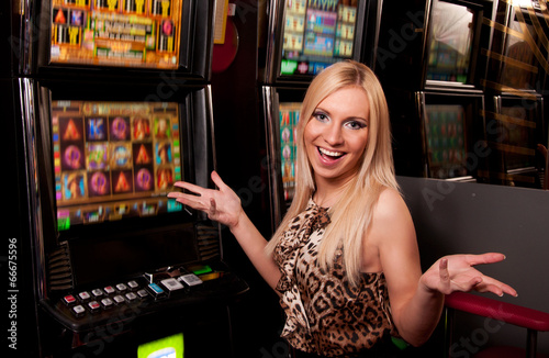 Young woman in Casino on a slot machine