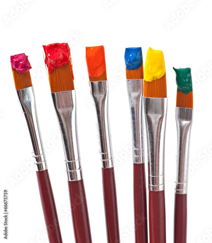 paint brushes with paint on white background