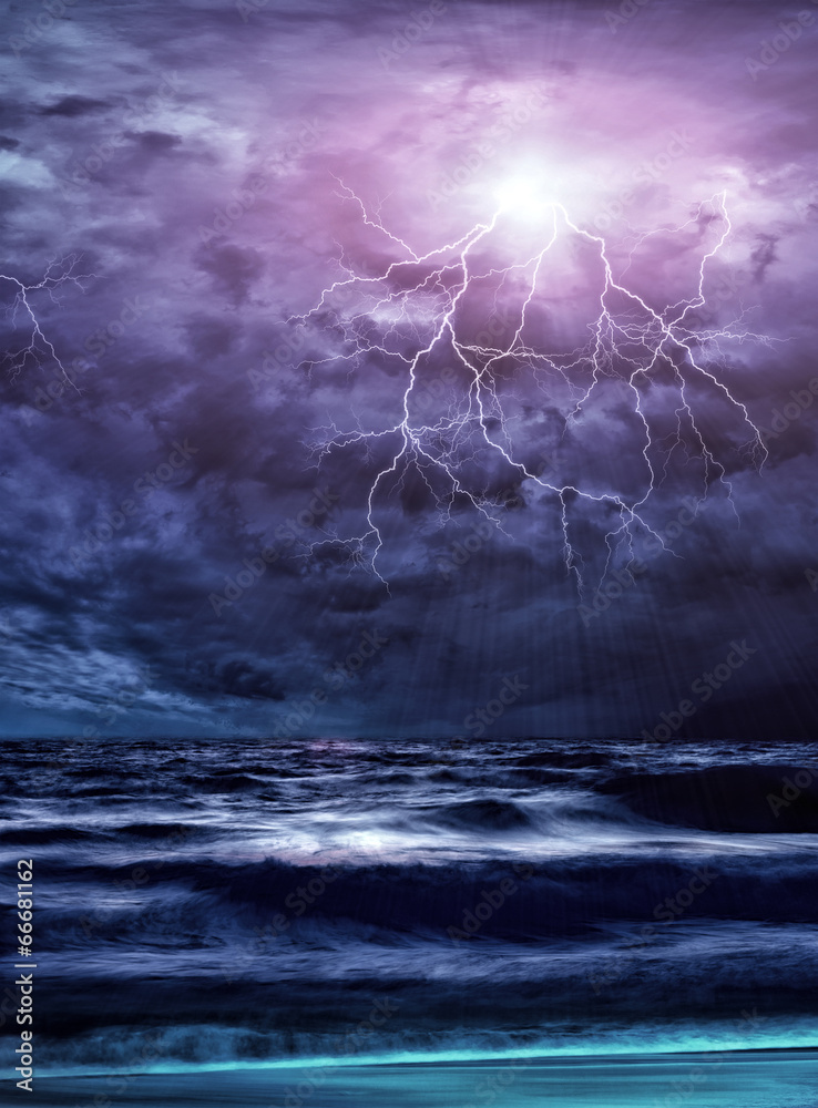 Fototapeta premium Lightning flashes across the beach from a storm