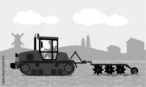 tractor processes the earth a rural landscape