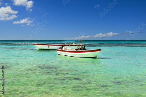 Boats on the azure sea on a background of blue sky